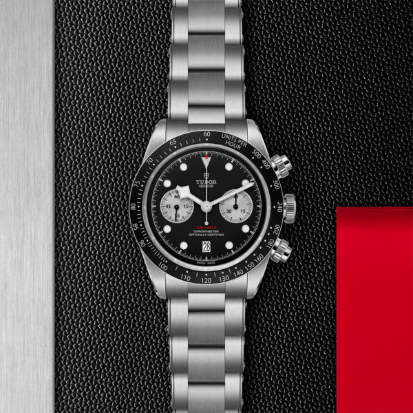 TUDOR Black Bay Pro Watch with a 41mm Steel Case, Steel Brace (M79360N-0001)Flat lay on black and red background