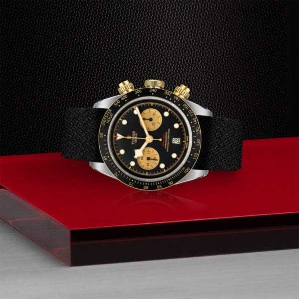 TUTOR Black Bay Pro Watch with a 41mm Steel Case, Black Fabric Strap (M79363N-0003) Laying Down on Red Tray