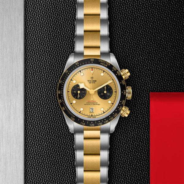 TUDOR Black Bay Bronze Chrono Watch S&G, 41 mm Steel Case, Steel and Yellow Gold Brace (M79363N-0007) Flat lay on black and red background