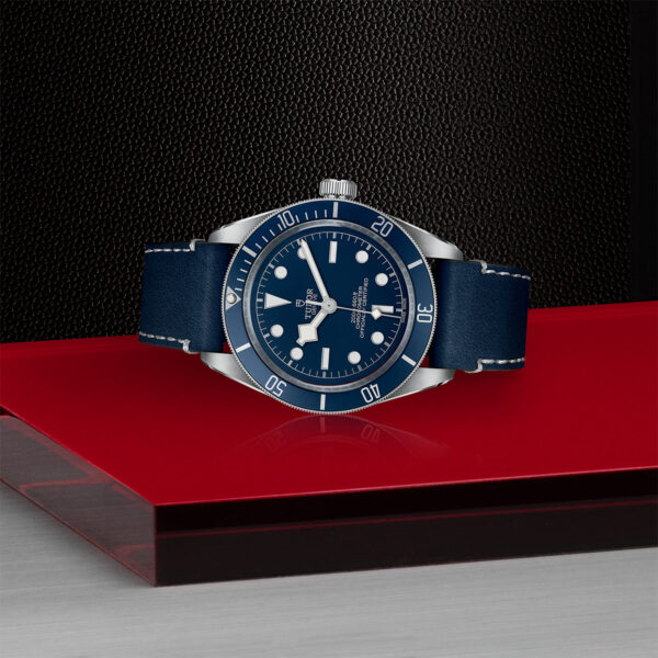 TUDOR Black Bay Fifty-Eight Watch, with a 39mm Steel Case, Blue 'Soft Touch' Strap (M79030B-0002) Laying Down on Red Tray