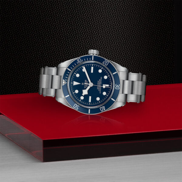 TUDOR Black Bay Fifty-Eight Watch with a 39mm Steel Case, Steel Bracelet (M79030B-0001) Laying Down on Red Tray
