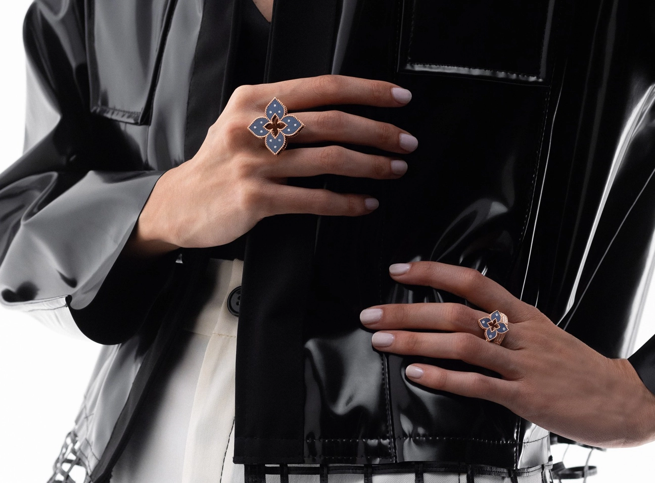 Woman holding back purse with rings on fingers