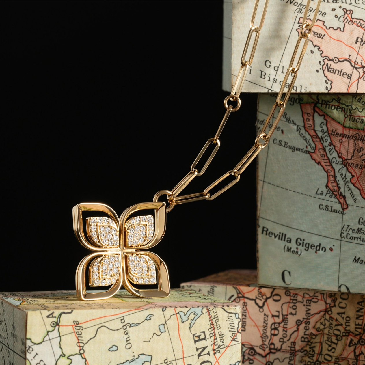 necklace on boxes with map images