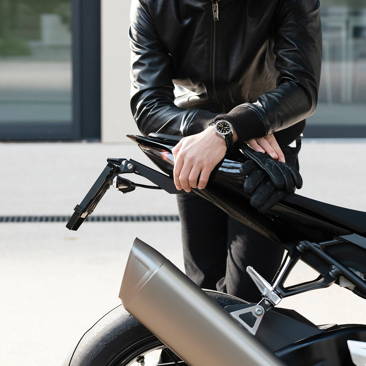 Man standing in leather jacket wearing a TUDOR Watch