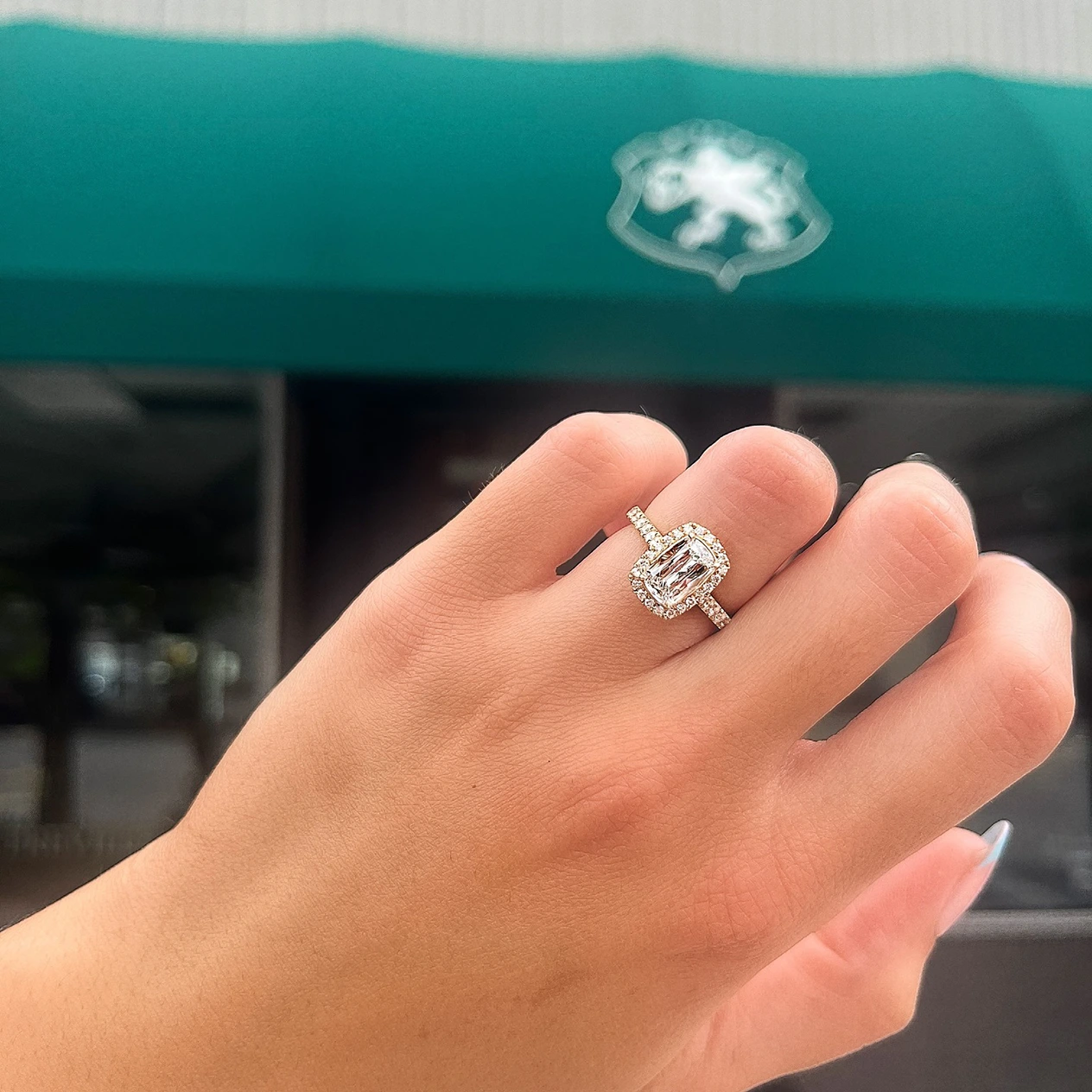 Hand with square diamond engagement ring