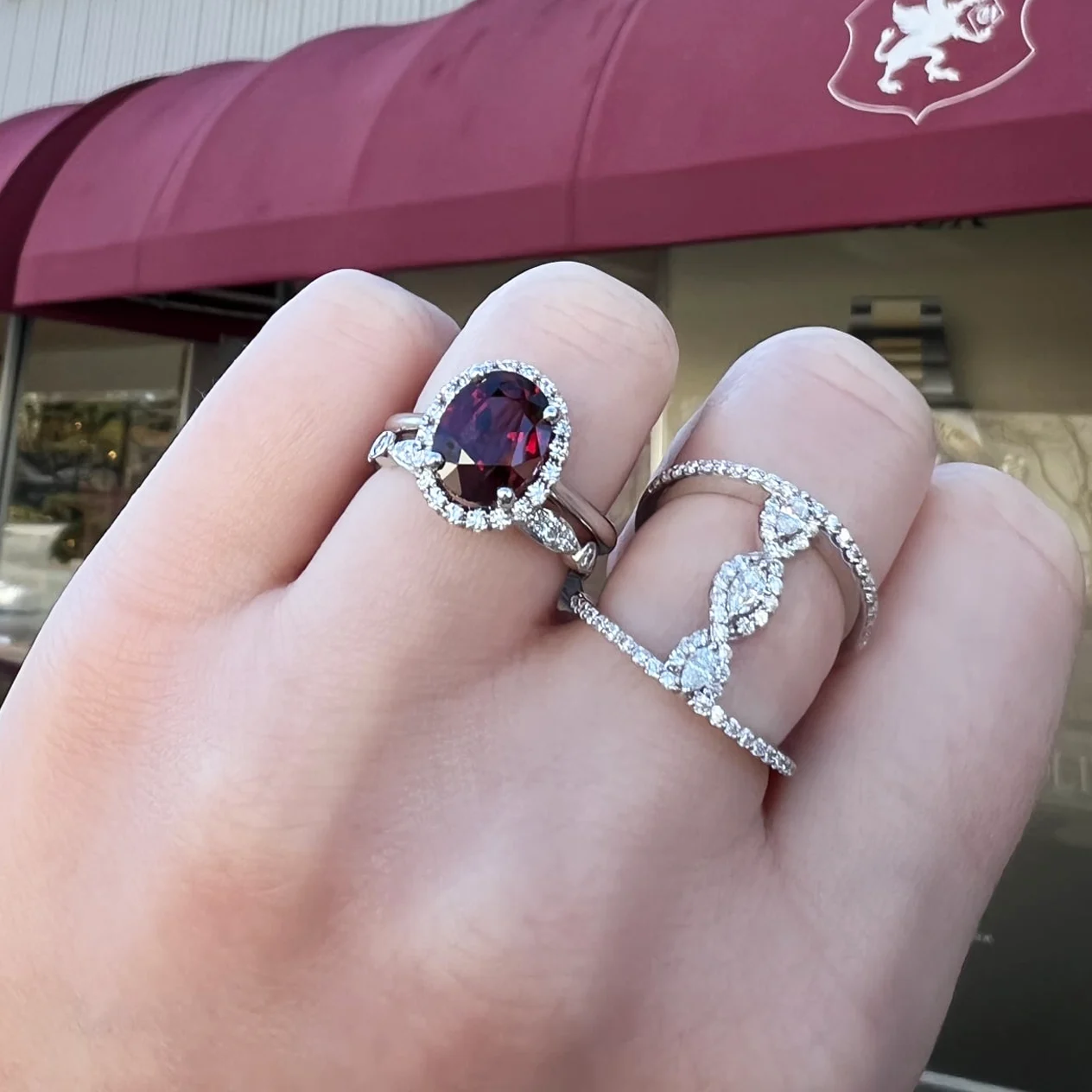 Garnet and diamond rings on hand