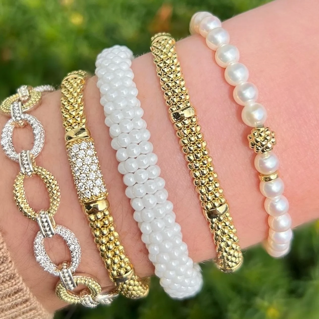 Pearl and gold bracelets on wrist