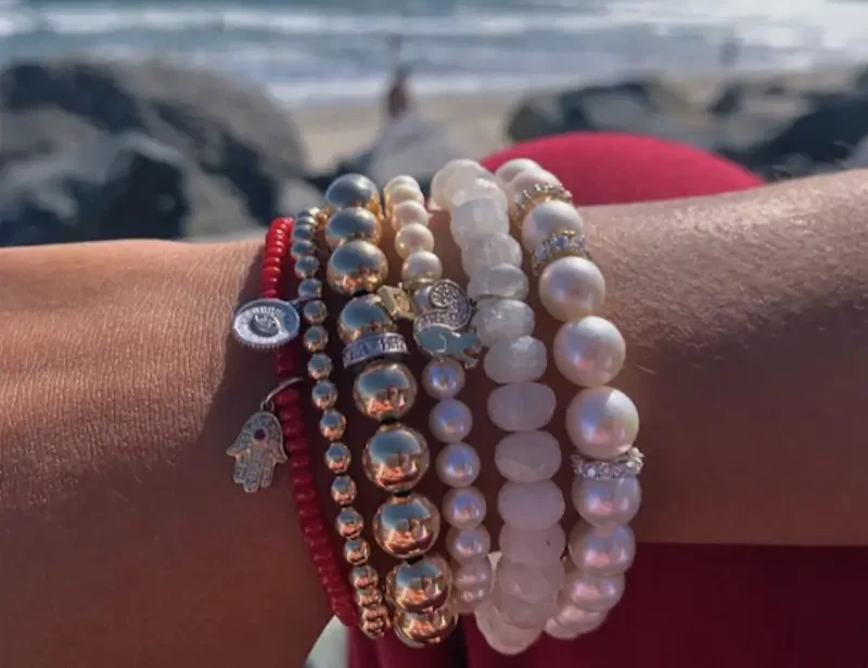 bracelets on model's wrist on beach
