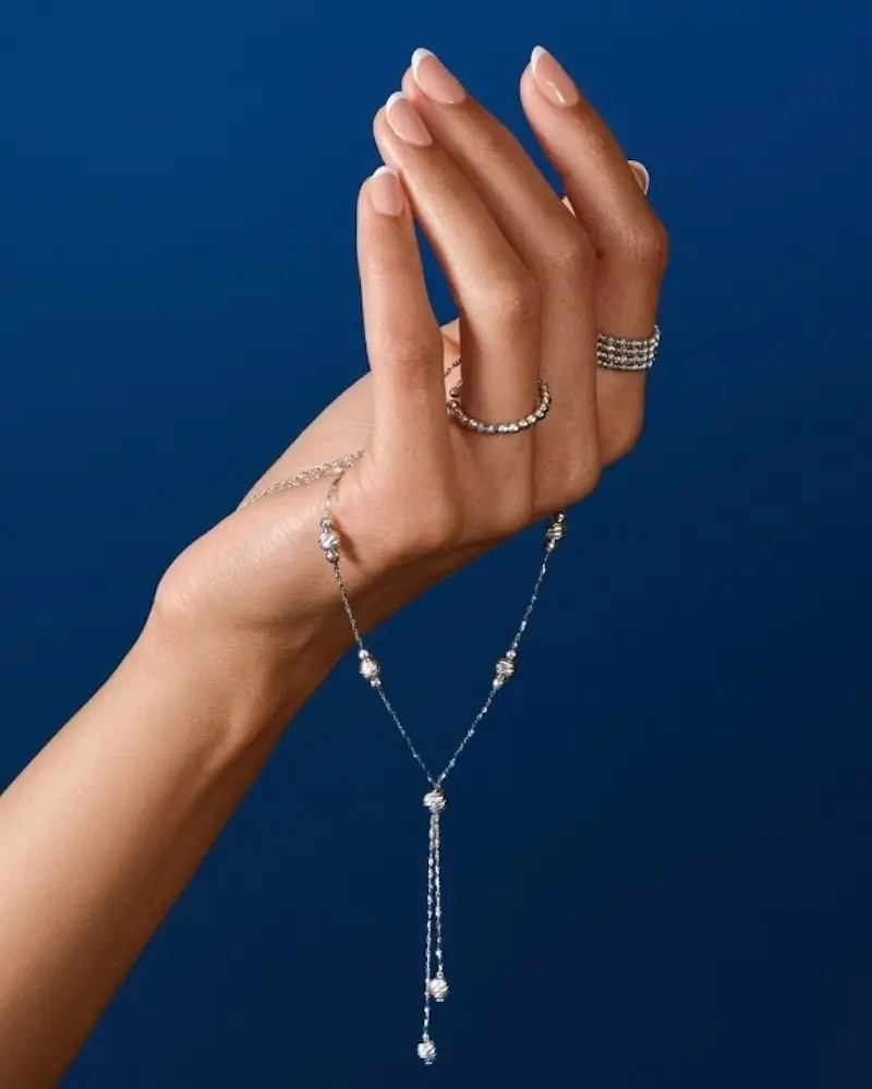 model holding various jewelry pieces