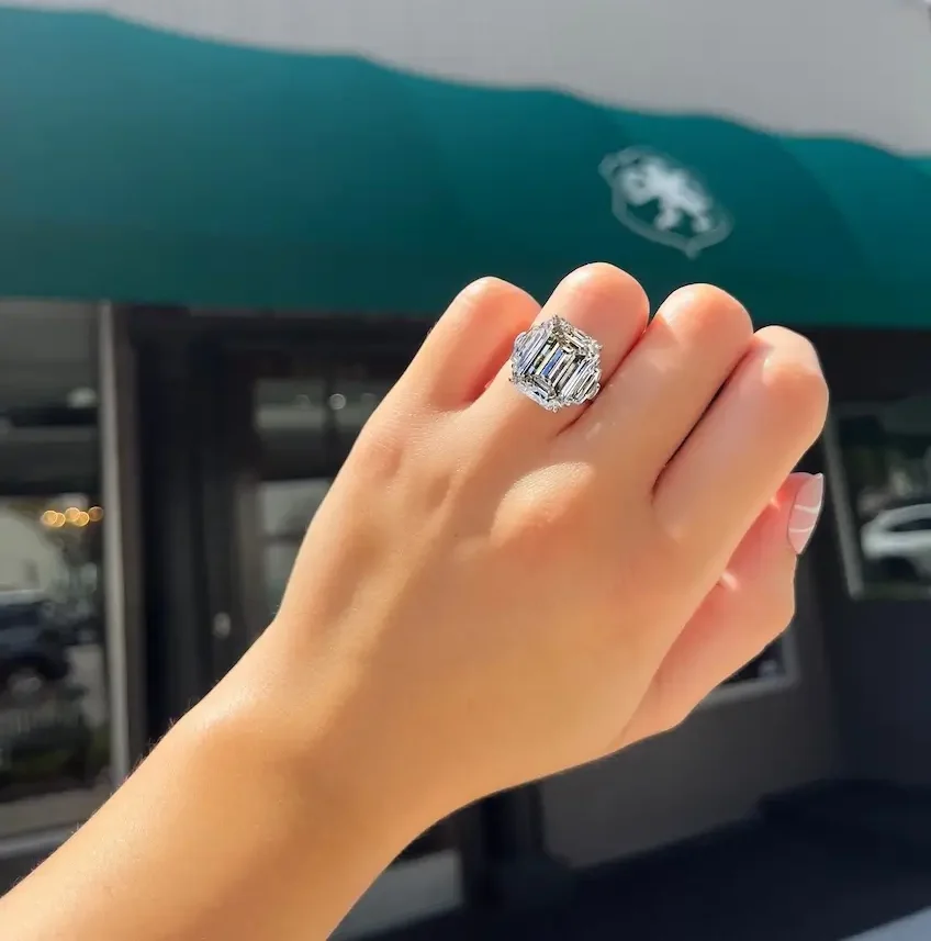 diamond ring on model's finger outside storefront