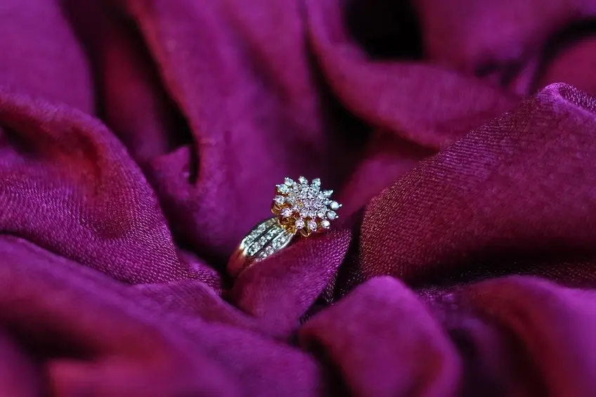 diamond ring displayed on maroon cloth