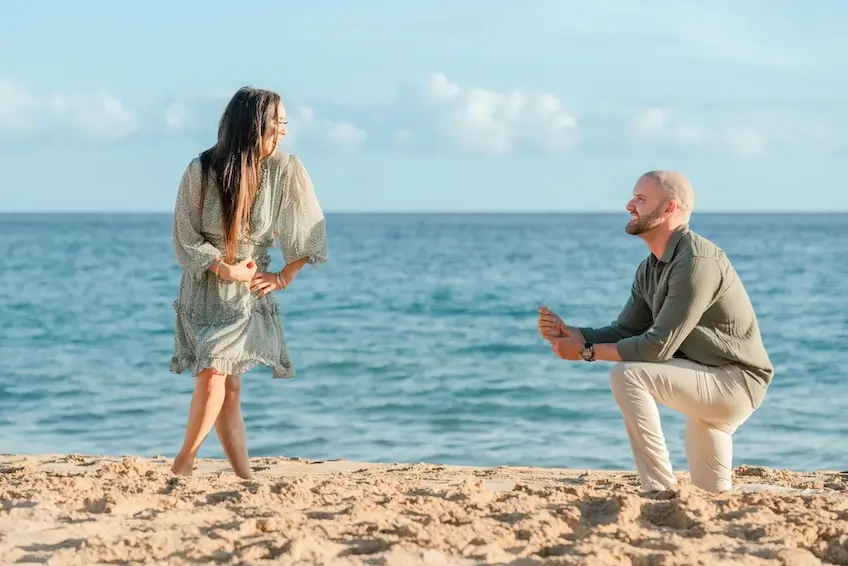man proposing to woman on the beachfront