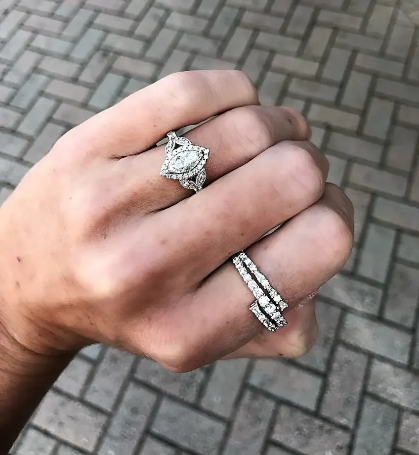 two vintage engagement rings on model's fingers