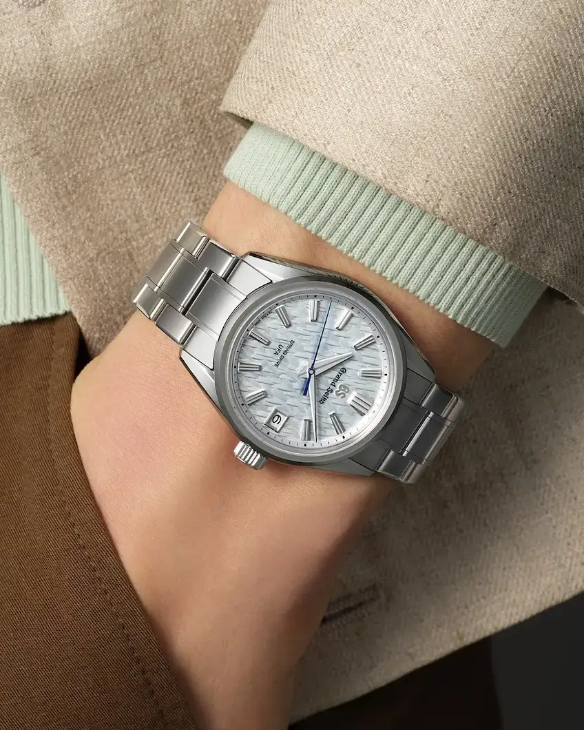 Grand Seiko Spring Drive watch on model's wrist, hand in pants pocket