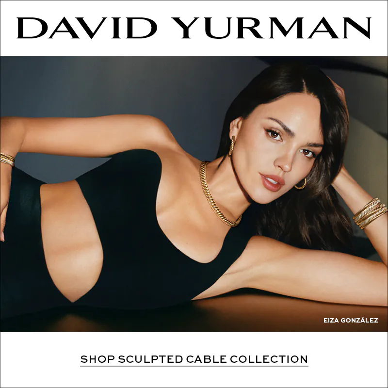 Elegant banner featuring a model reclining in a black outfit wearing yellow gold David Yurman Sculpted Cable jewelry including bracelets, rings, necklace, and hoop earrings, with “David Yurman – Shop Sculpted Cable Collection” text on the left and the name Eiza González displayed on the right.