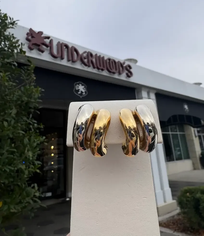 90s-inspired earrings on display outside, Underwood's storefront in background