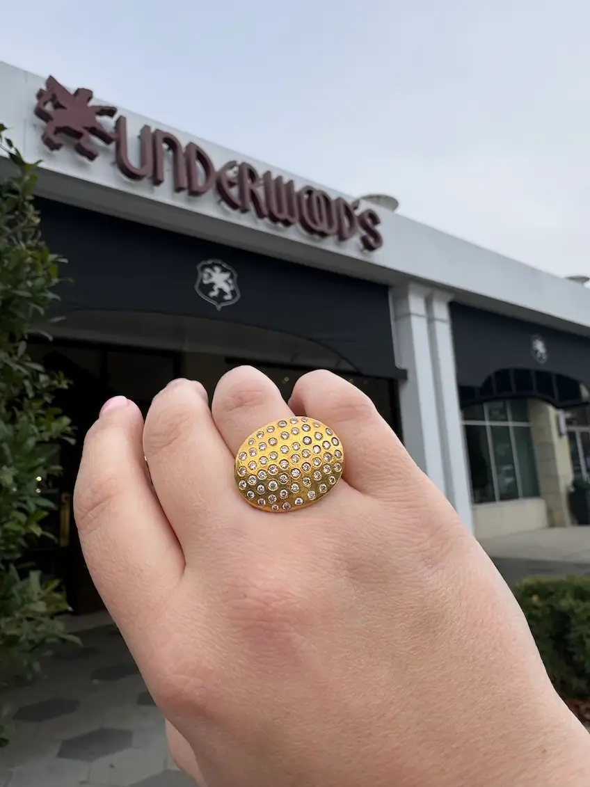 90s statement ring on woman's finger