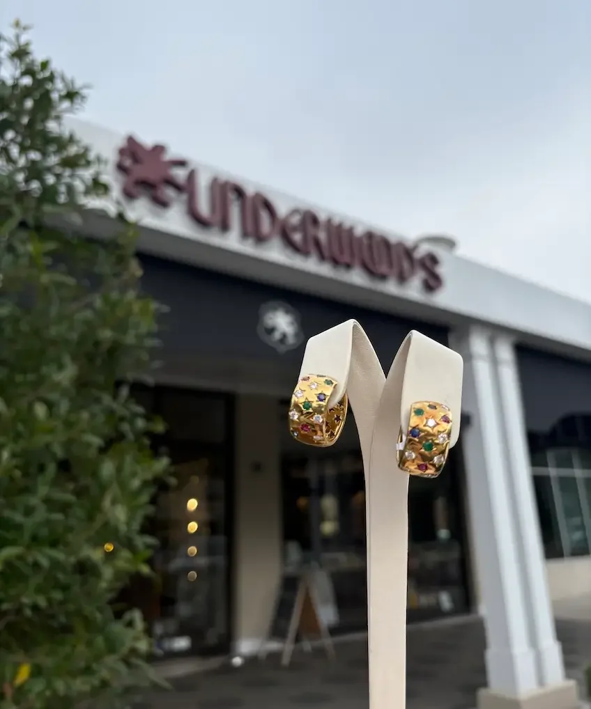 90s-inspired earrings on display outside, Underwood's storefront in background