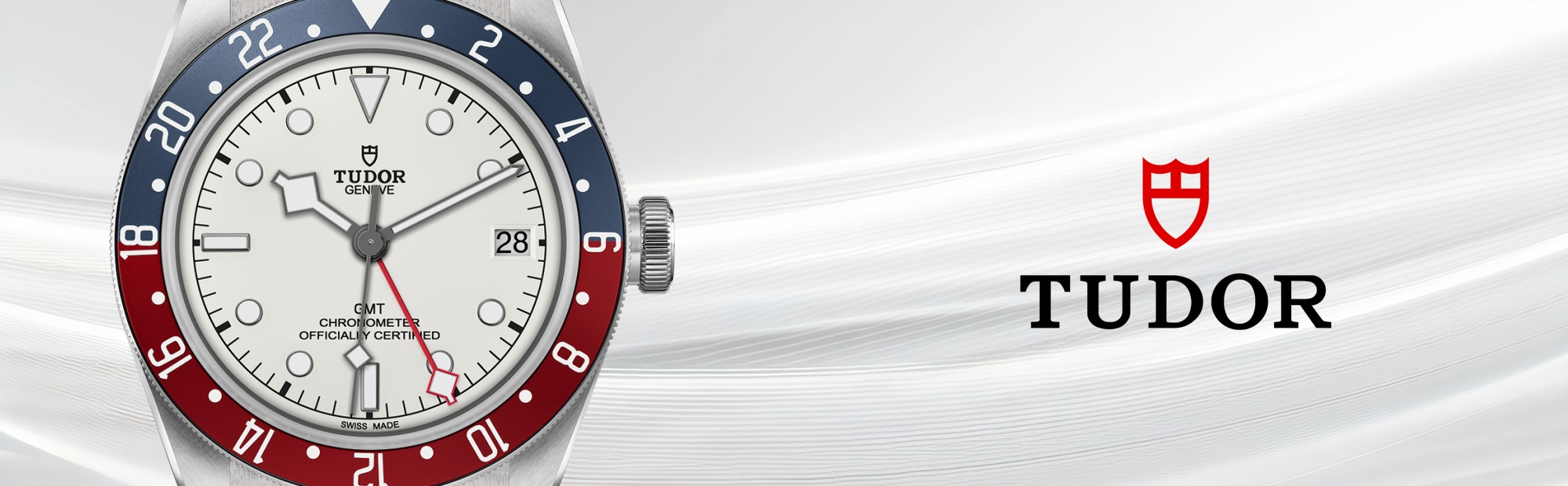 Banner featuring a TUDOR Black Bay GMT watch in stainless steel with a white dial, red and blue “Pepsi” bezel, date window, and red GMT hand, displayed beside the TUDOR shield logo on a light textured background.