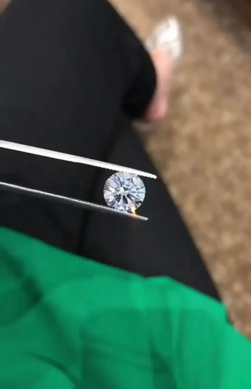 a loose diamond held by tweezers