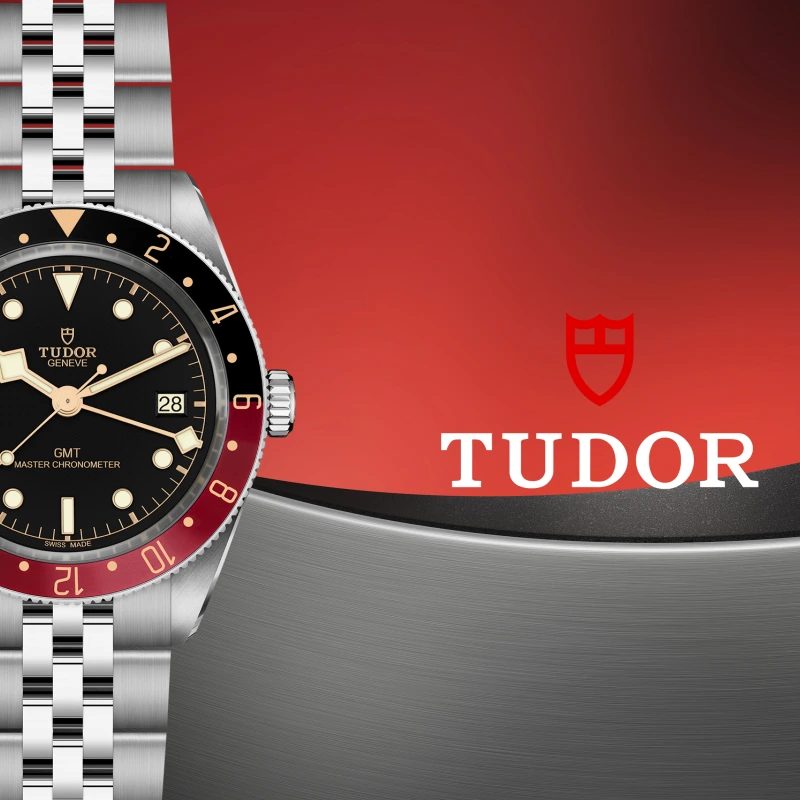 Banner featuring a TUDOR Black Bay 58 GMT watch in stainless steel with a black dial and red and black bezel displayed beside the TUDOR log on a gray and red background.