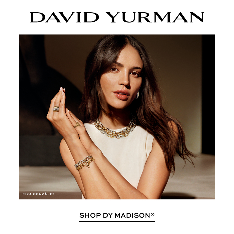 Square David Yurman campaign image featuring a model wearing layered mixed-metal Madison Collection necklaces, bracelets, rings, and earrings. The David Yurman logo appears at the top, with "Shop DY Madison®" displayed below the image on a clean white background.