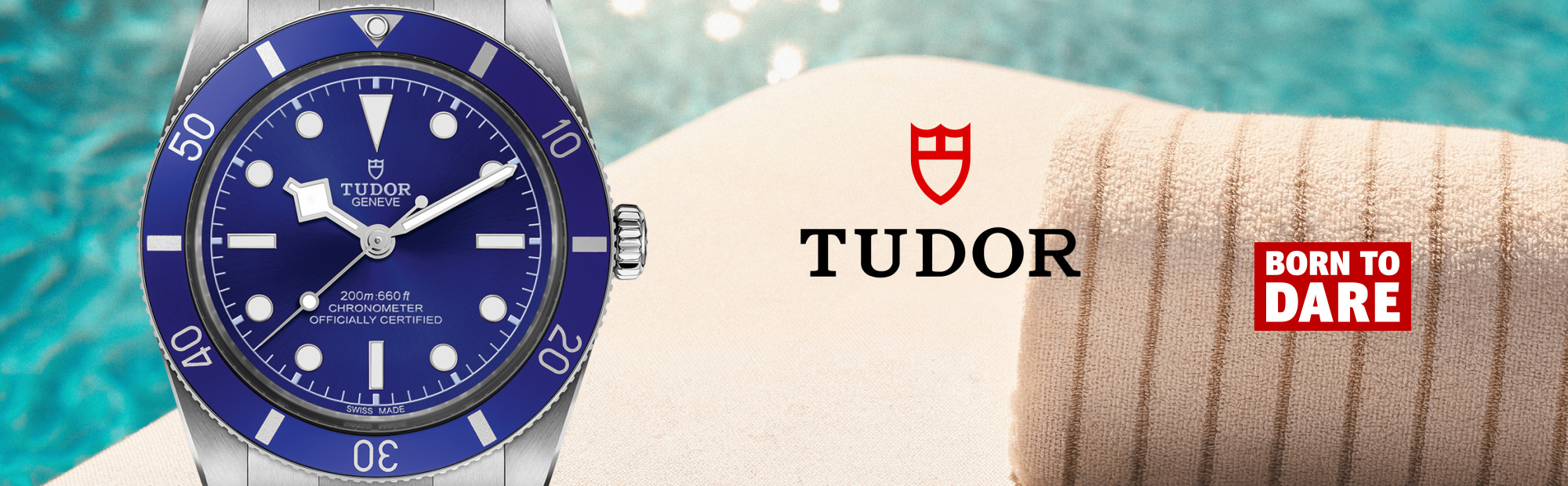 Wide banner featuring the TUDOR Black Bay 54 Blue stainless steel dive watch with a vivid blue dial and bezel against a sunlit poolside backdrop. A rolled beach towel, the TUDOR logo, and the Born To Dare campaign logo complete the summer-inspired composition.